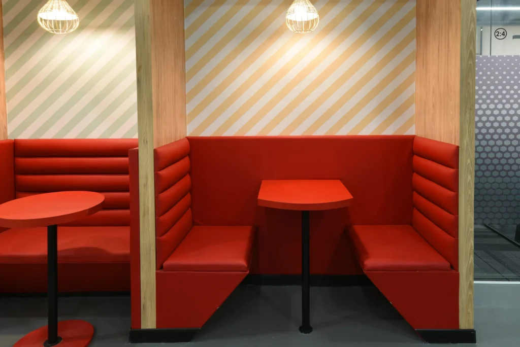 yessswork booth with red themed sitting 3 scaled (1)